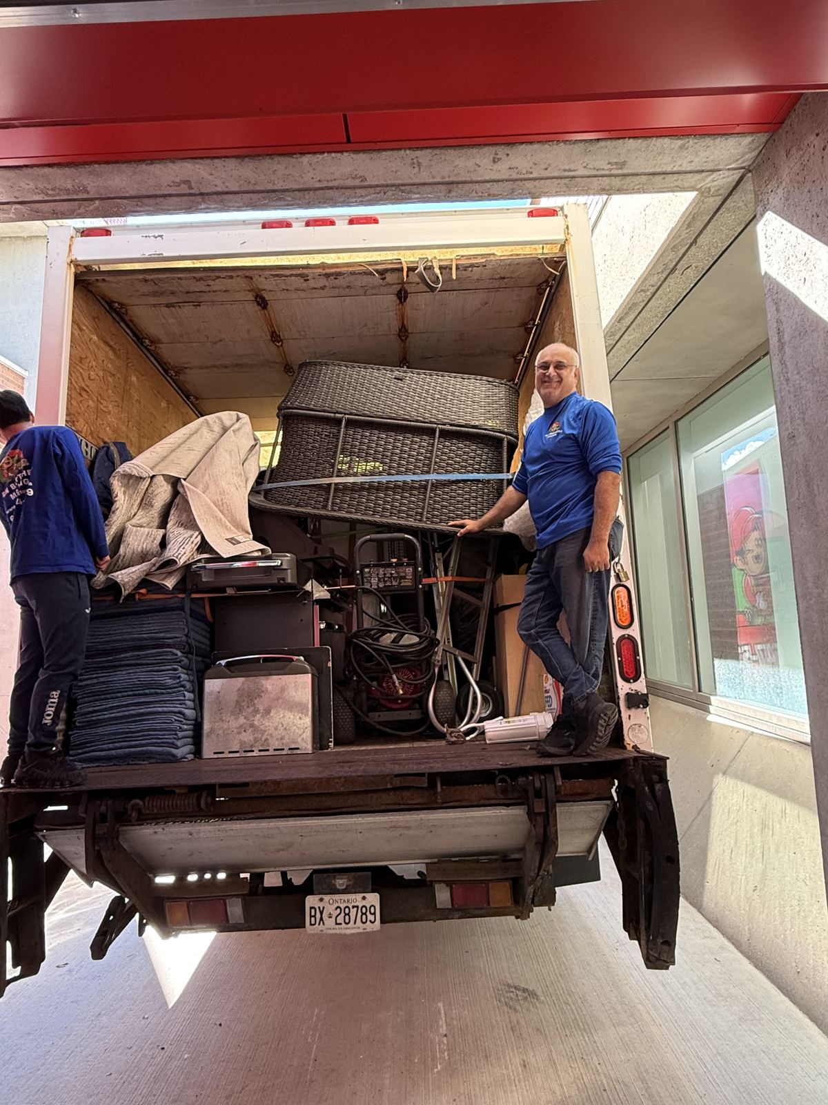 Movers loading a truck at a loading dock for a business move in Mississauga